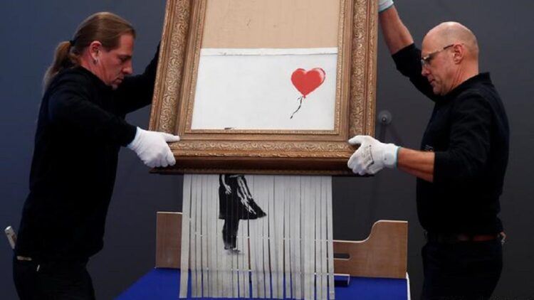 Sudah Tercabik-cabik, Lukisan Banksy Dilelang dengan Harga Selangit 1 Meski sudah dicabik-cabik mesin, lukisan Banksy ini masih dilelang dengan harga selangit. (reuters)