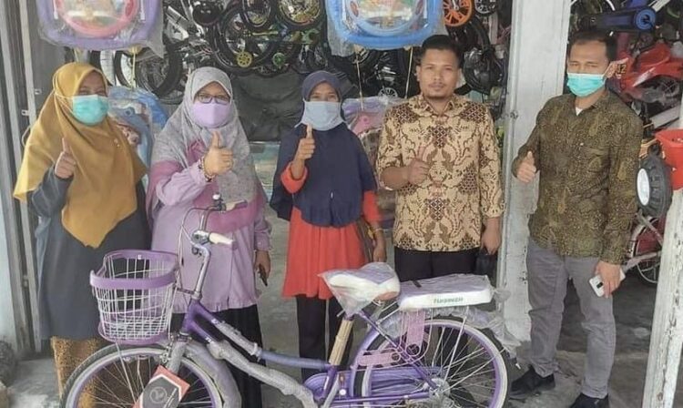 8 Tahun Jalan Kaki, Penjual Kue Bahagia Diberi Sepeda 1 Baznas Kota Padang memberikan bantuan 1 unit sepeda kepa penjual kue, Yerlinawati, diserahkan Wakil Ketua II Baznas Kota Padang Elni Sumiarti.
