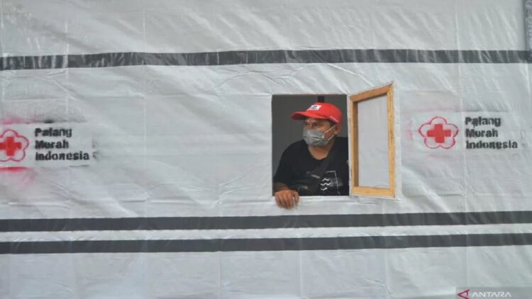 Relawan berada di contoh hunian sementara yang dibangun Palang Merah Indonesia (PMI) untuk korban gempa di Nagari Kajai, Kabupaten Pasaman Barat, Sumatera Barat, Senin (7/3/2022). ANTARA FOTO/Iggoy el Fitra/hp.