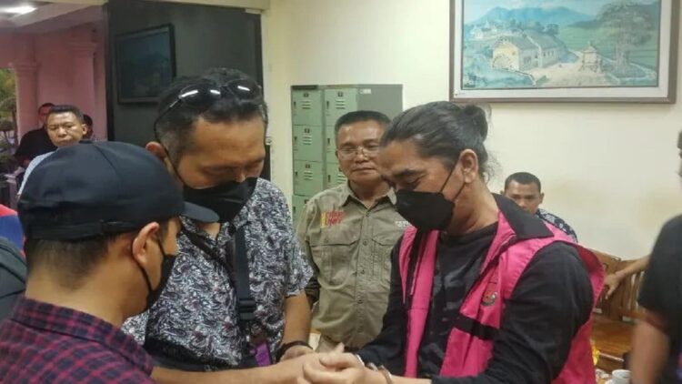 Tersangka DK (rompi merah jambu) dikawal oleh tim kejaksaan saat mendarat di BIM Padangpariaman dari Jakarta, pada Sabtu (16/7). (ANTARA/Fathul Abdi)