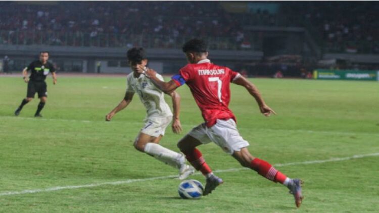Marselino Ferdinan mengalami cedera saat Timnas Indonesia U-19 ditahan imbang tanpa gol melawan Thailand U-19 pada laga ketiga Grup A Piala AFF U-19 2022 di Stadion Patriot Candrabhaga, Rabu (6/7/2022) malam WIB. (Foto: MPI/Aldhi Chandra)