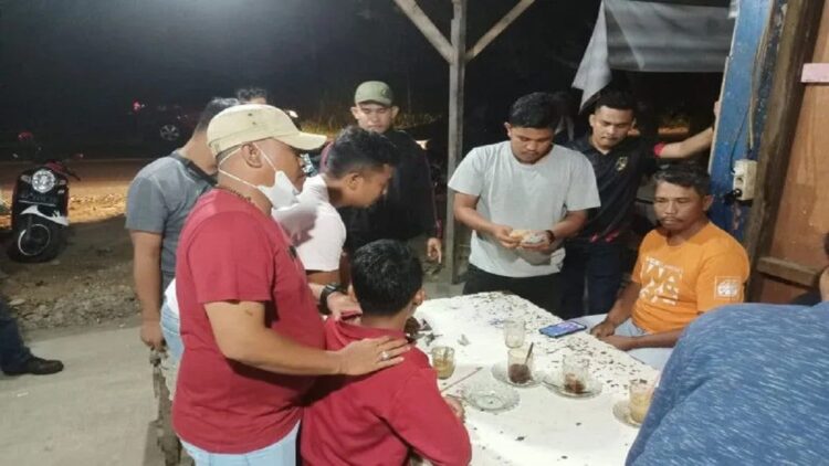 Anggota sedang menangkap pelaku yang sedang bermain judi, Minggu (15/8/2022). (Antara/Dok Polres Agam)