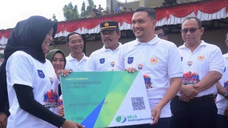 Kepala BPJS Ketenagakerjaan Cabang Solok Maulana Anshari Siregar menyerahkan secara simbolis kartu kepesertaan Jamsostek kepada perwakilan atlet Porkot Sawahlunto Tahun 2022, baru-baru ini. (Antarasumbar/Yudha Ahada)