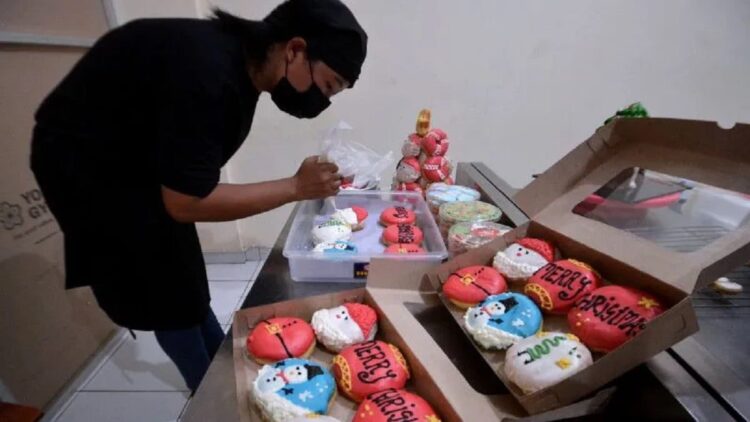 Karyawan menyelesaikan proses pembuatan donat bertema Natal di Kania Cake, Badung, Bali, Rabu (21/12/2022). ANTARA FOTO/Fikri Yusuf/YU (ANTARA FOTO/FIKRI YUSUF)