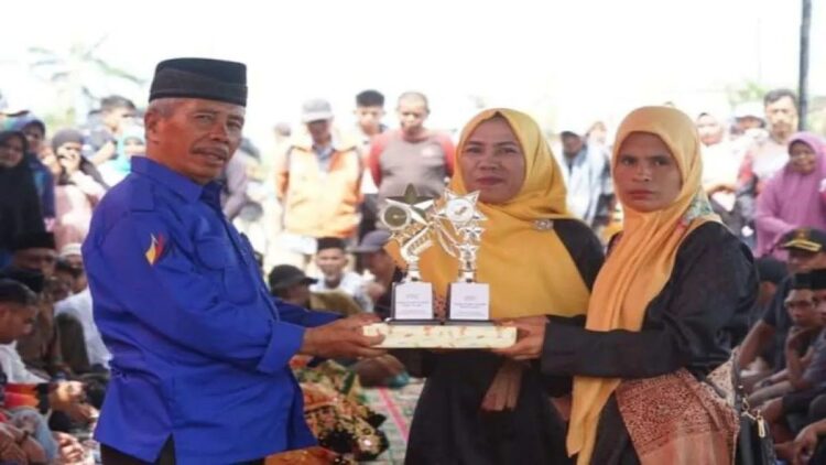 Ketua Persatuan Olahraga Pacu Jawi (Porwi) Kabupaten Tanahdatar, Aresno Dt. Andomo (kiri) saat menyerahkan tropi di salah satu event pacu jawi di Kabupaten Tanah (Antara/HO).