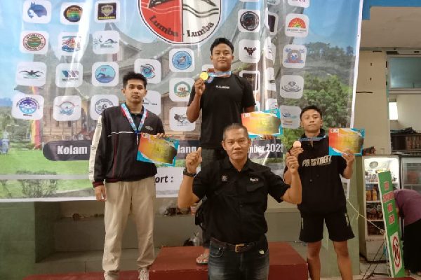 Panitia pelaksana Minangkabau Open Swimminy Championship, Juhardio Anse memberikan medali dan piagam kepada peserta lomba renang se-Sumatera. (Foto: Dok. Radarsumbar.com)