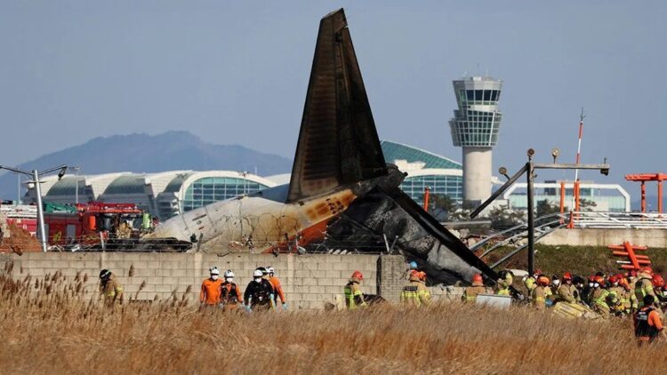 Petugas pemadam kebakaran berada di sekitar pesawat Jeju Air yang keluar dari landasan pacu di Bandara Internasional Muan, Muan, Provinsi Jeolla Selatan, Korea Selatan, Minggu (29/12/2024). ANTARA FOTO/ REUTERS/YONHAP/Spt.