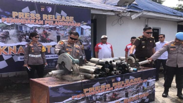 Wakil Kepala Polres Pasaman Barat Kompol Chairul Amri Nasution (tengah) didampingi Kasat Lantas AKP Rina Aryanti saat memotong knalpot menggunakan mesin pemotong, Senin (13/1/2024). ANTARA/Altas Maulana.