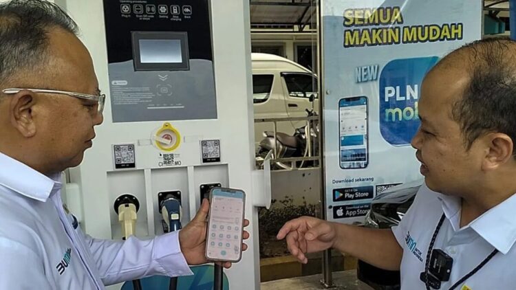General Manager PLN UID Sumatera Barat Ajrun Karim (kanan) menunjukkan tata cara pengisian daya kendaraan listrik menggunakan aplikasi PLN Mobile di Padang, Senin (10/3/2025). (ANTARA/Muhammad Zulfikar)