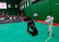 Pesilat putri Sumbar Paula Listi di Kelas C Putri membanting pesilat Maluku, Eka P. Dewi Polpoke. Paula menang mutlak atas40–10. (Foto Humas KONI Sumbar)