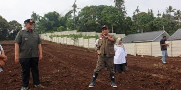 Sekretaris Utama BNPB Rustian didampingi Wakil Bupati Tanah Datar meninjau 1,8 hektare lahan kosong yang diperkirakan dapat dibangun sekitar 34 hingga 70 unit huntap terpadu di Kecamatan Rambatan, Kabupaten Tanah Datar pada Rabu (7/1/2026). (Foto: BNPB)